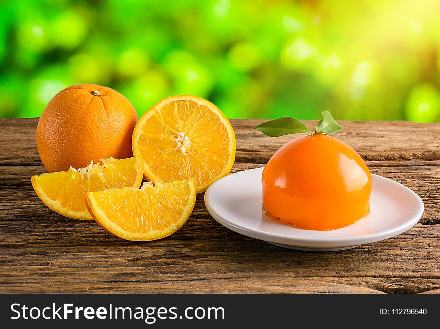 Orange Cake with Orange Shape, Half crescent, Full Fresh Orange Fruit on grunge wooden table. Orange Cake with Orange Shape, Half crescent, Full Fresh Orange Fruit on grunge wooden table