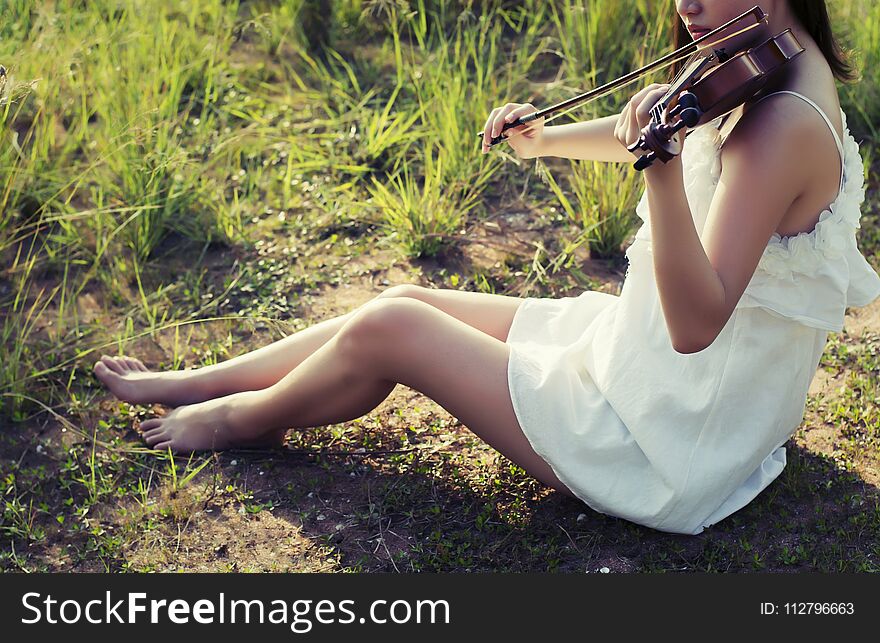 Beautiful woman enjoy playing violin Colorful flowers. Beautiful woman enjoy playing violin Colorful flowers