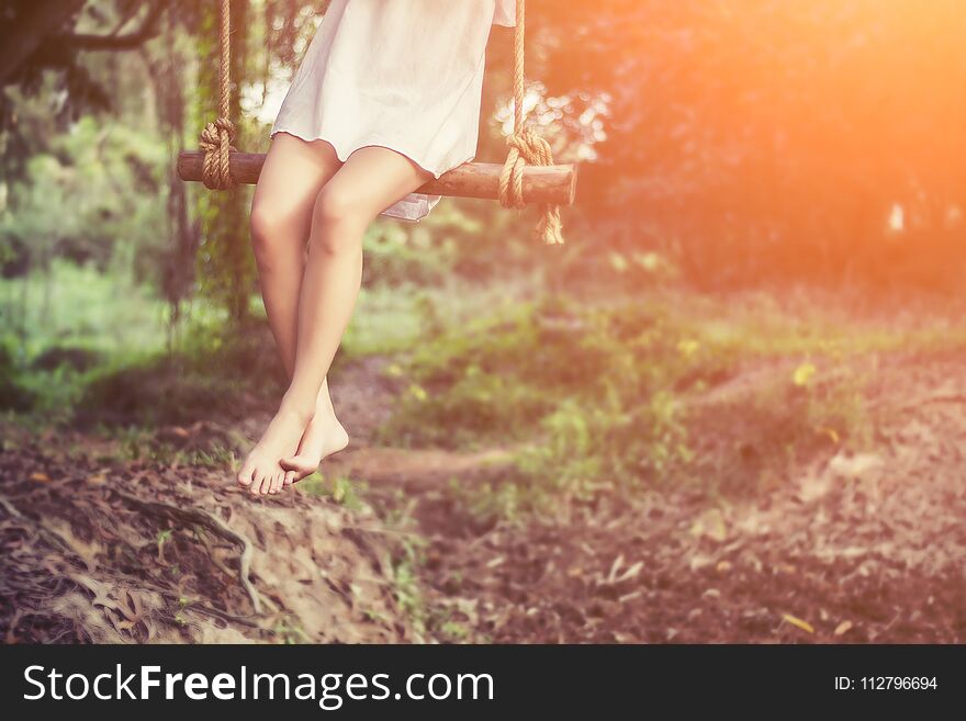 Beautiful women are sitting swings very happy.