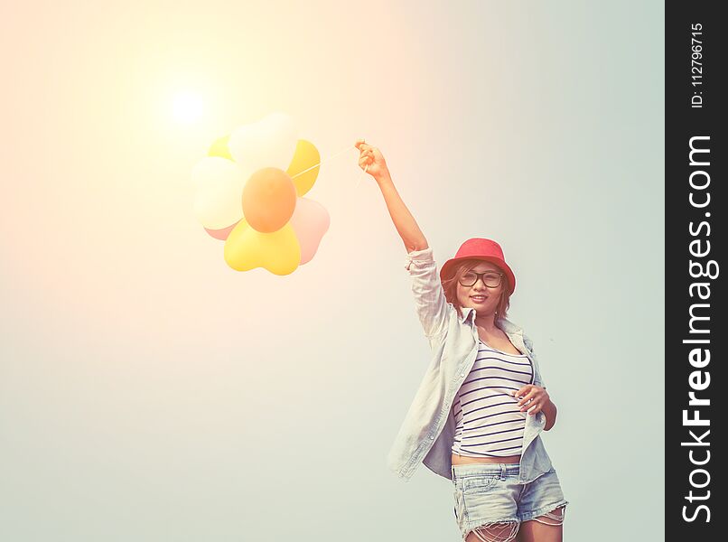 Young beautiful woman holding balloon very happy on the fresh air background