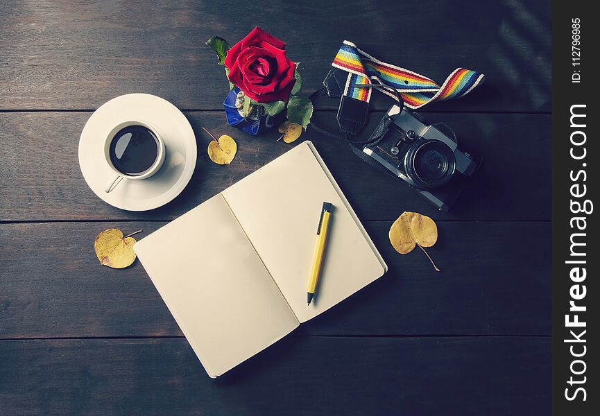 Top view coffee and cup and a plate and a blank memory book with