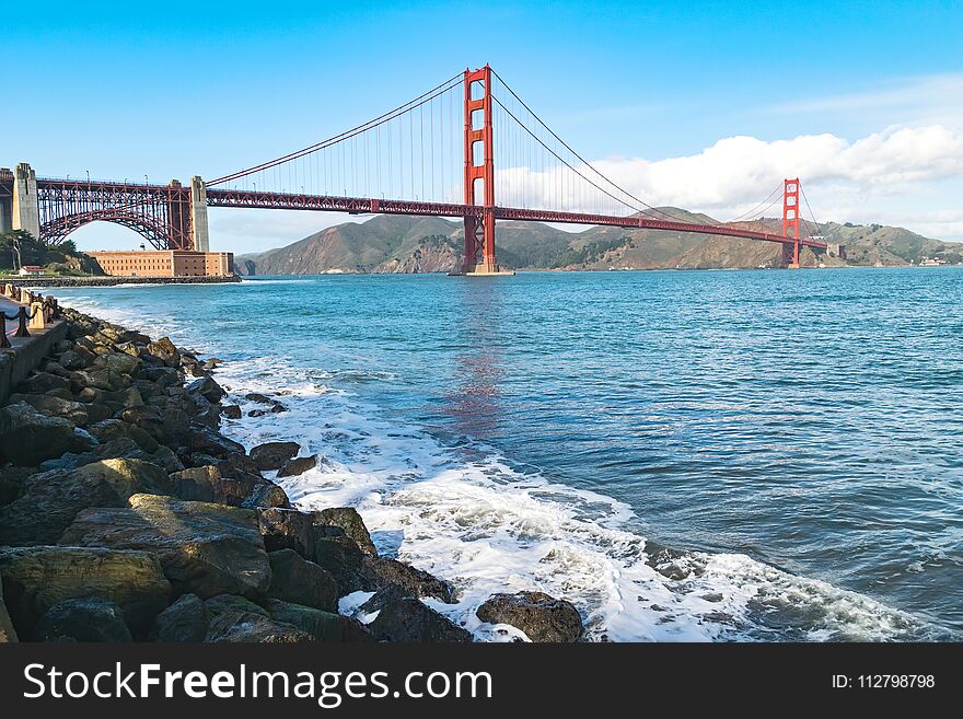 Golden Gate Bridge in San Francisco on a sunny day, picture taken by the coastline. Golden Gate Bridge in San Francisco on a sunny day, picture taken by the coastline