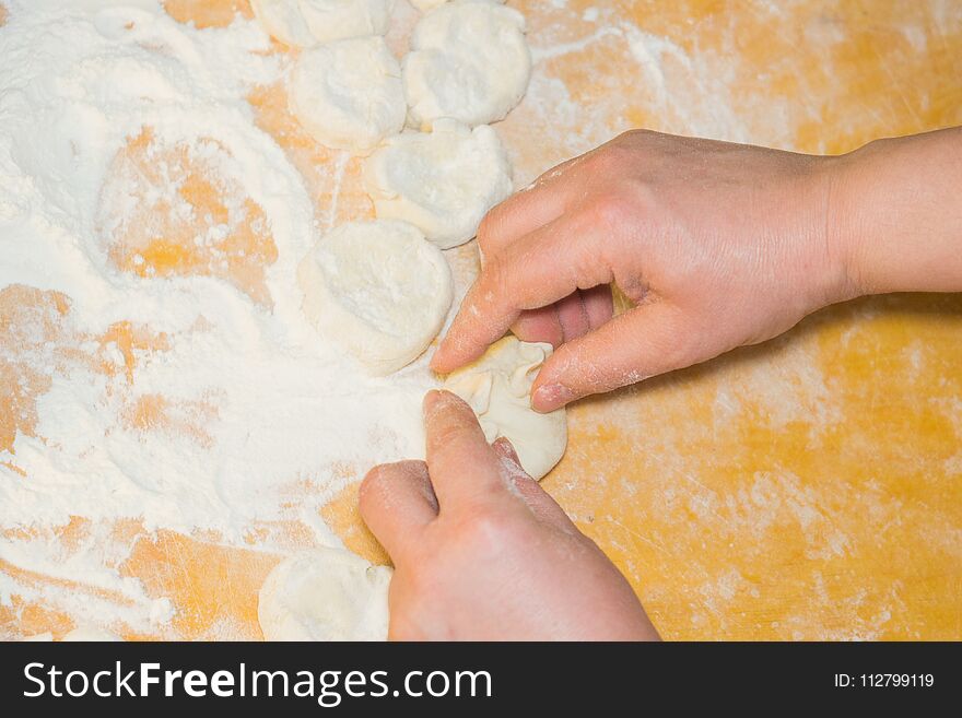 Home cooking pies stuffed with cabbage hands of a woman. Home cooking pies stuffed with cabbage hands of a woman