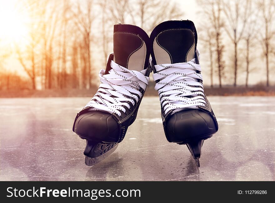 Black hockey skates on a ice rink. Winter sport.