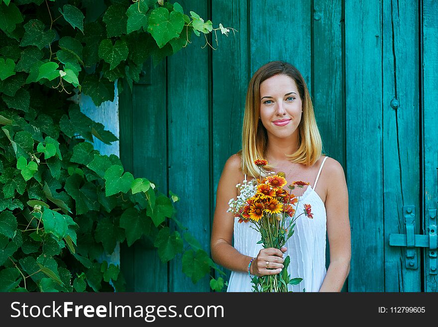 Young Girl On A Summer Day With Wildflowers