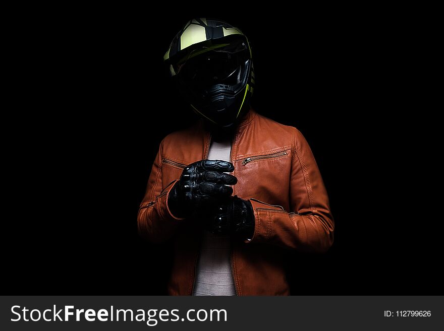 Low Key Male Biker On ISolated Black Background.