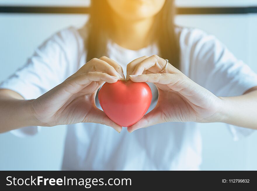 Woman hands holding red heart from patient,Health care checking concept