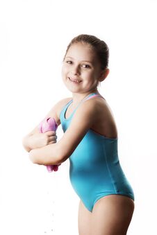 Little Caucasian 7 Years Old Cute Caucasian Girlie In Cyan Swimming Costume Twistting A Pink Shammy Royalty Free Stock Image