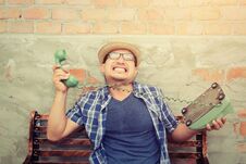 Hipster Man Tried To Use The Phone. And He Do A Wrong With Phone Stock Image