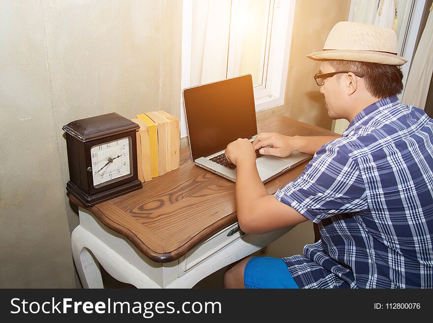 Young hipster man using notebook to searching information