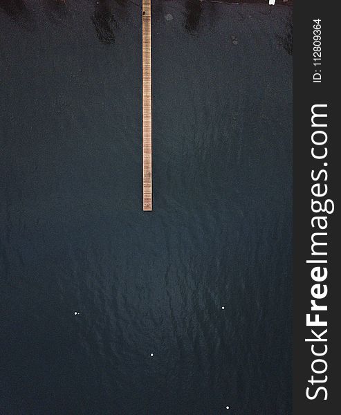 Brown Wooden Dock on Top of Body of Water