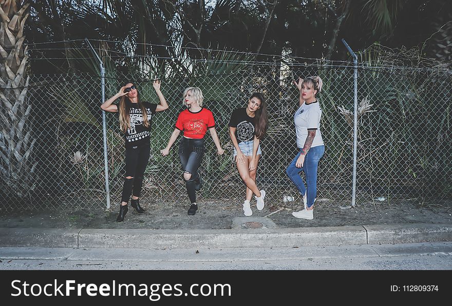 Four Girls Near Fence