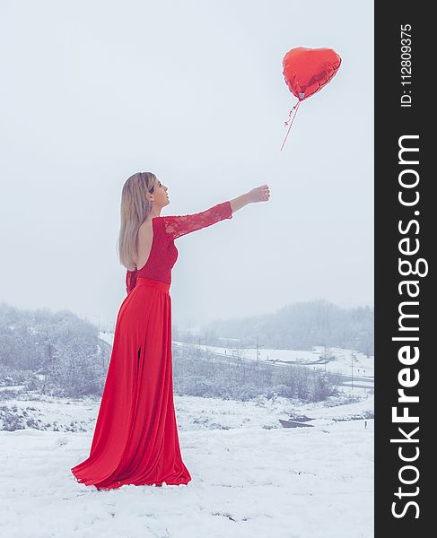 Woman In Red Floral Lace Long-sleeved Dress Standing With Red Heart Balloon