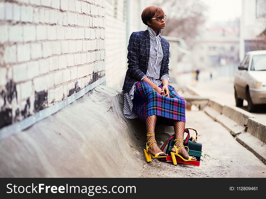 Woman Sitting Of Concrete Stair Near Gray Car