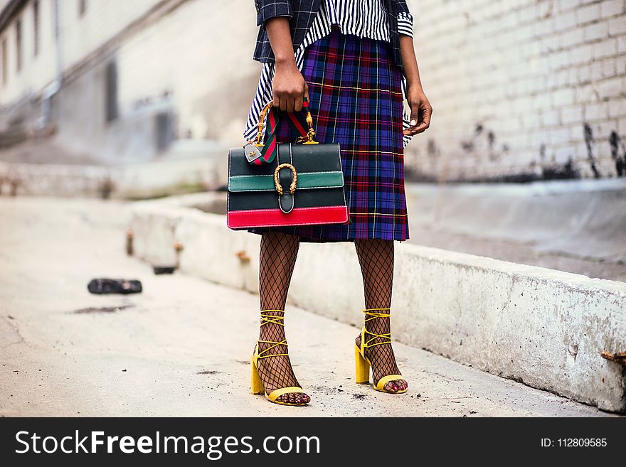 Woman Holding Green and Red Leather Handbag