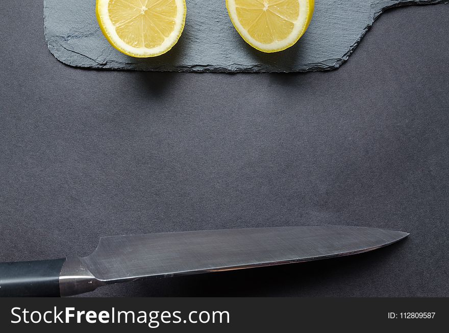 Sliced Lemon and Gray Knife