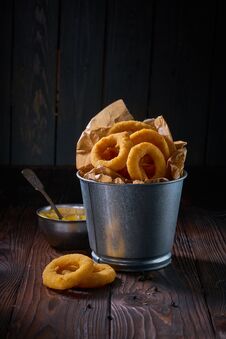 Fried Onion Rings With Sauce Served In Metal Backet On Wooden Table Royalty Free Stock Image Fried Onion Rings With Sauce Served In Metal Backet On Wooden Table Royalty Free Stock Image