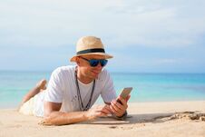 Man With Mobile Phone On The Beach Stock Images