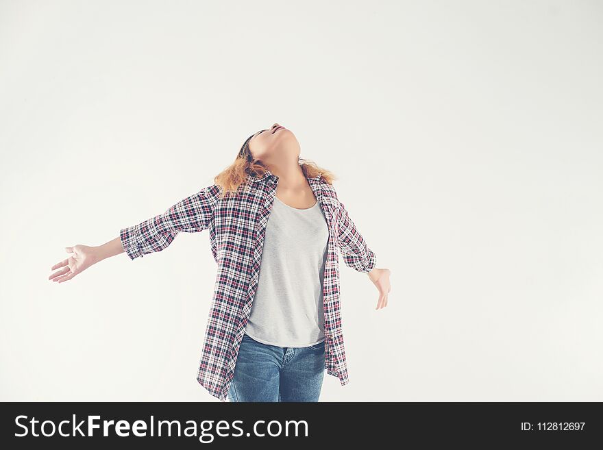 Freedom young hipster woman raising hands with isolated over a white background.