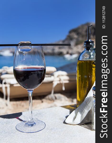 Lunch on the shore of the Mediterranean sea. Red wine with ice, olive oil. Noon in Rhodes. Lunch on the shore of the Mediterranean sea. Red wine with ice, olive oil. Noon in Rhodes