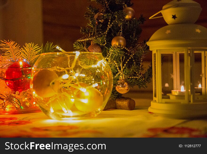 Festive new year mood. The fire candles and light colorful garlands. The approach of Christmas and new year.