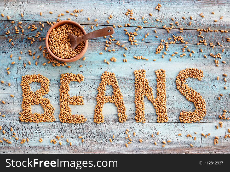 Beans On The Table Bakground With Bowl And Spoon