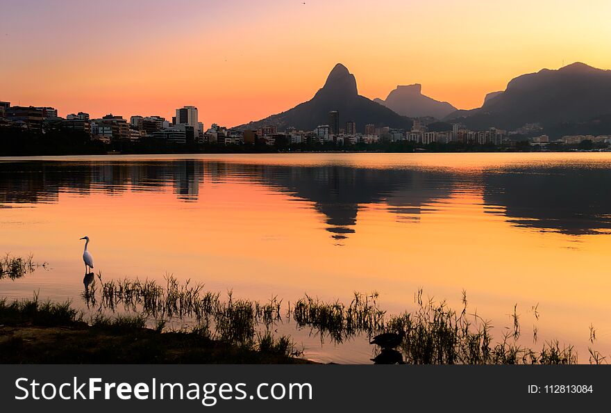 Beautiful View of Rio de Janeiro Sunset Behind Mountains at Rodrigo de Freitas Lake.