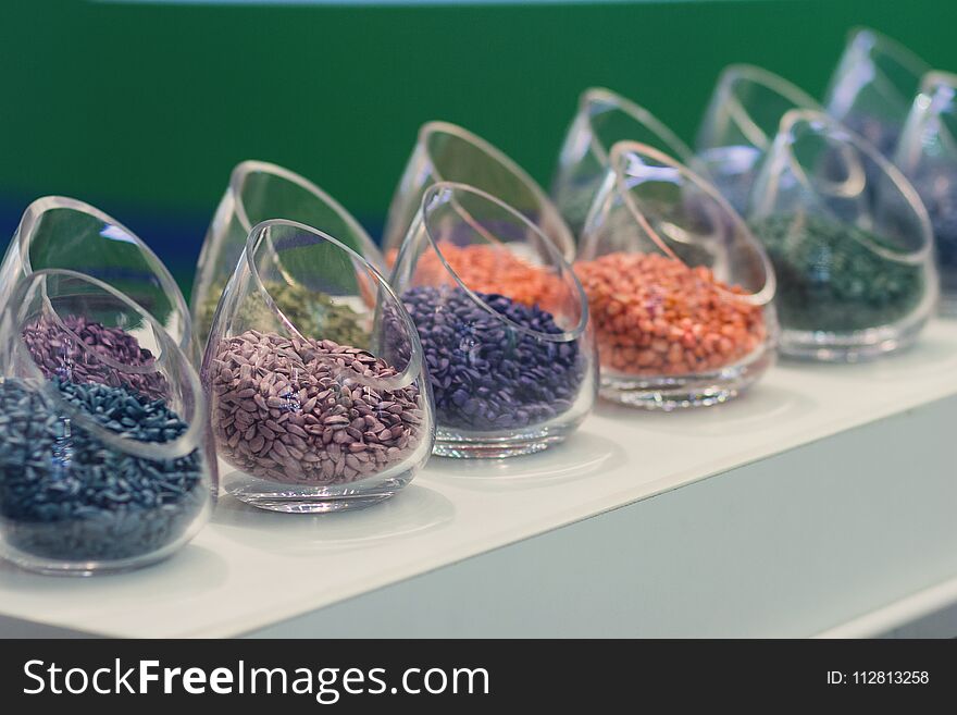 Multicolored seeds on the exhibition stand. Agriculture