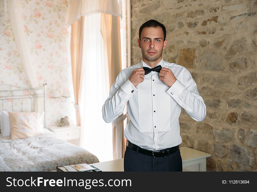 Morning Of The Groom. Businessman Morning Preparation. Young And Handsome Groom Getting Dressed In A Wedding Shirt