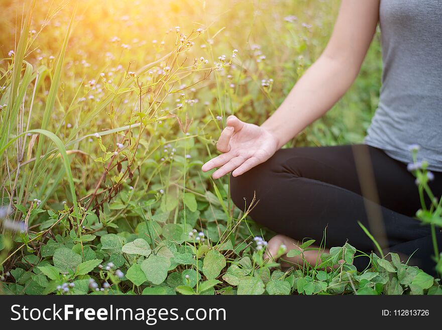 Beautiful woman in lotus position practicing yoga.