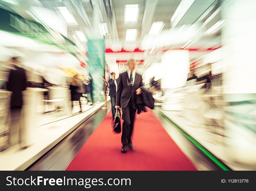 Blurred crowd of people at a trade fair hall. Blurred crowd of people at a trade fair hall