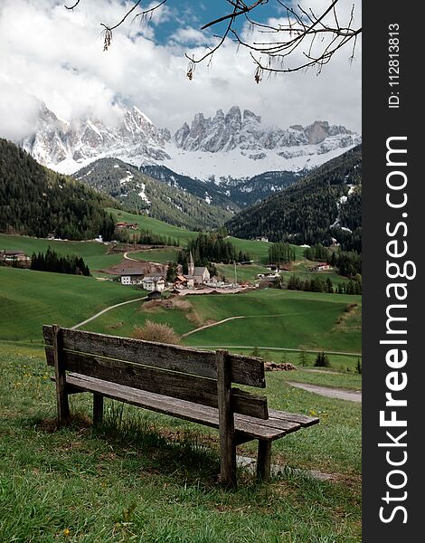 A bench with a view of the mountains. Lookout in the north of Italy. val di funes. Dolomites