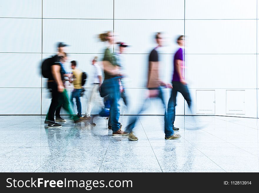 Blurred people at a trade fair hall