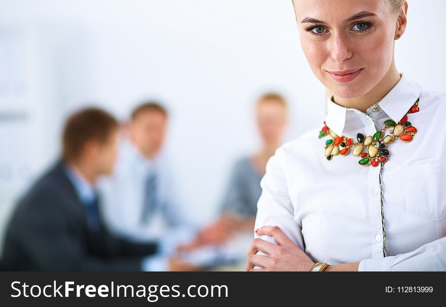 Portrait of a young woman working at office standing