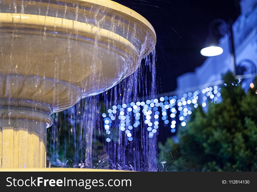 Fountain On The Street In The Evening.