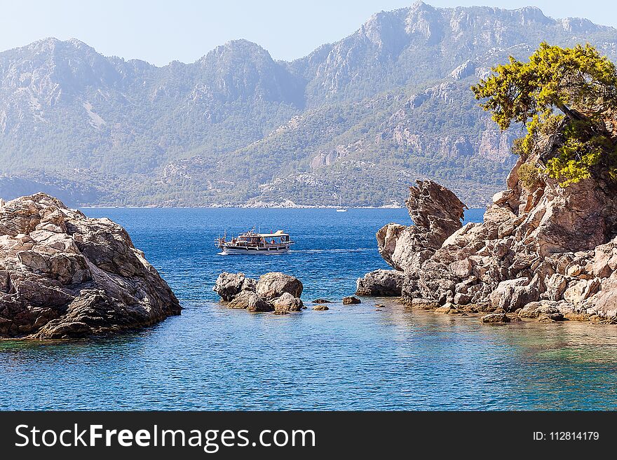 Rocks And Boat On The Sea.