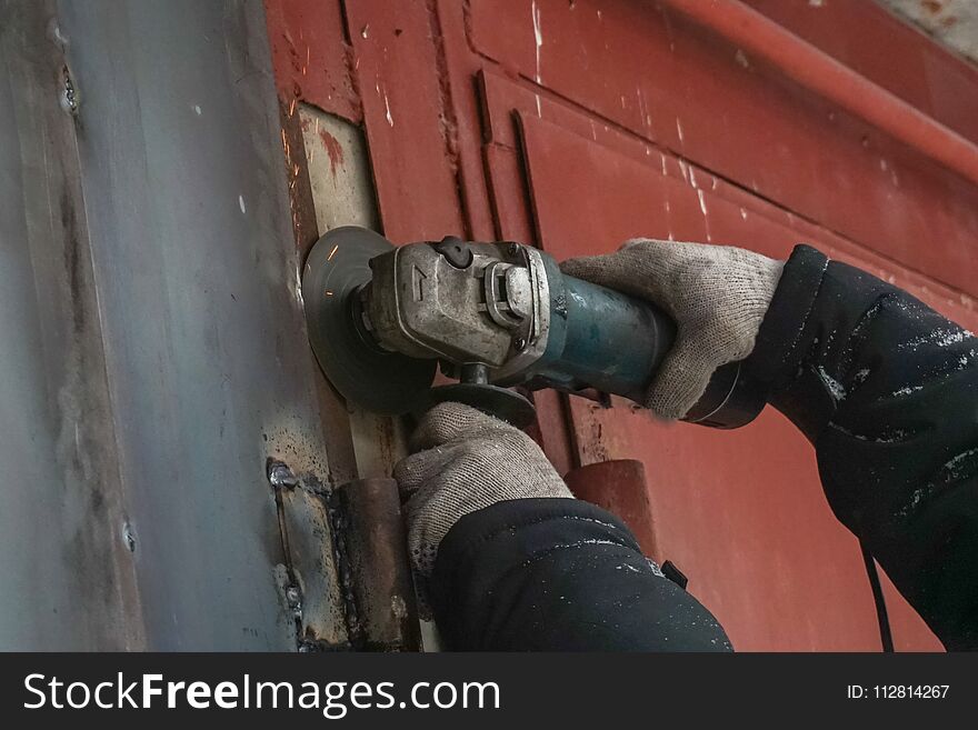 Man conducts welding works outdoors in winter. Man conducts welding works outdoors in winter