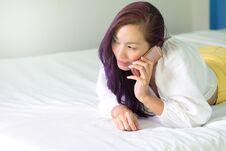 Woman Using A Smart Phone On Bed. Stock Photo