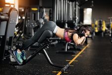 Athletic Young Woman Doing Hyperextension In The Gym. Woman Flexing Back And Abdominal Muscles On Bench. Royalty Free Stock Image