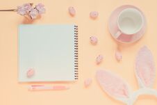 Easter Holiday Background With Notebook And Pen, Cup For Coffee, Bunny Ears And Easter Eggs Stock Image