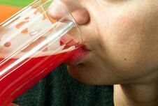 Close Up Of Girls Face And Lips Drinking Strawberry Red Juice From The Glass As Refreshment, Real People, Selective Focus Stock Images