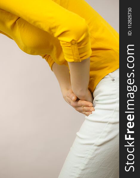 Closeup young sick woman with hands holding pressing her crotch lower abdomen. Medical or gynecological problems, healthcare concept. Closeup young sick woman with hands holding pressing her crotch lower abdomen. Medical or gynecological problems, healthcare concept