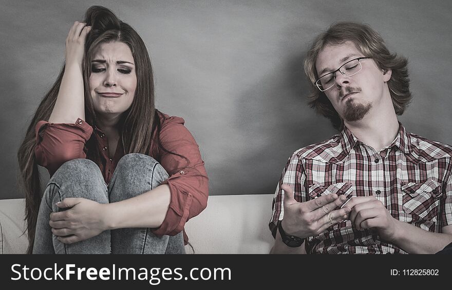 Woman and man after argue on sofa