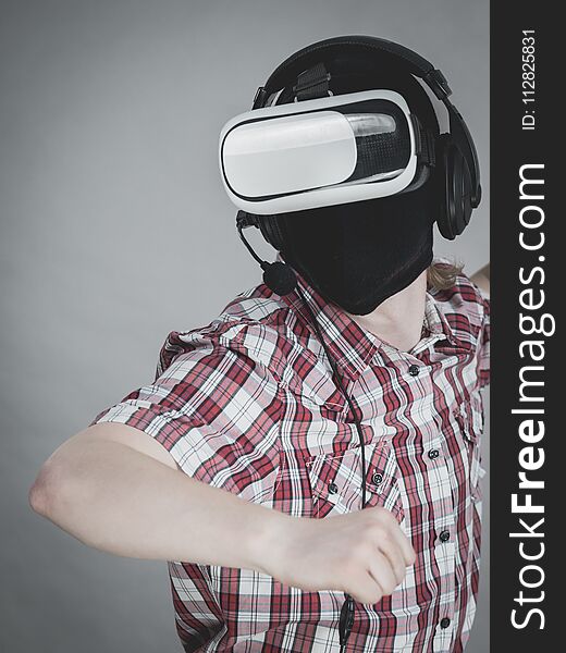Man playing video game wearing virtual reality device. Gaming equipment for gamers concept. Man playing video game wearing virtual reality device. Gaming equipment for gamers concept.