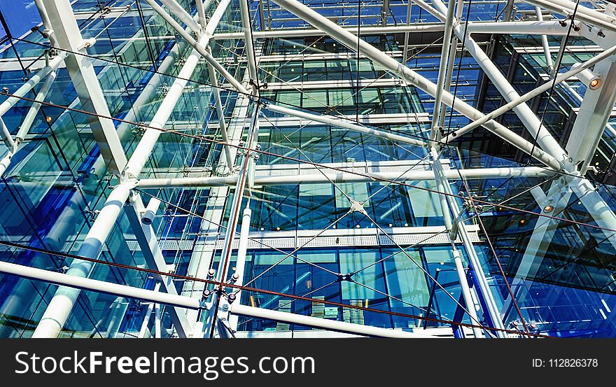 Metallic pipes and cords construction in a building with big windows