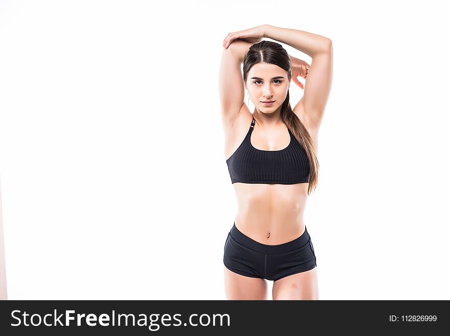 Young beautiful woman in fitness wear over white background