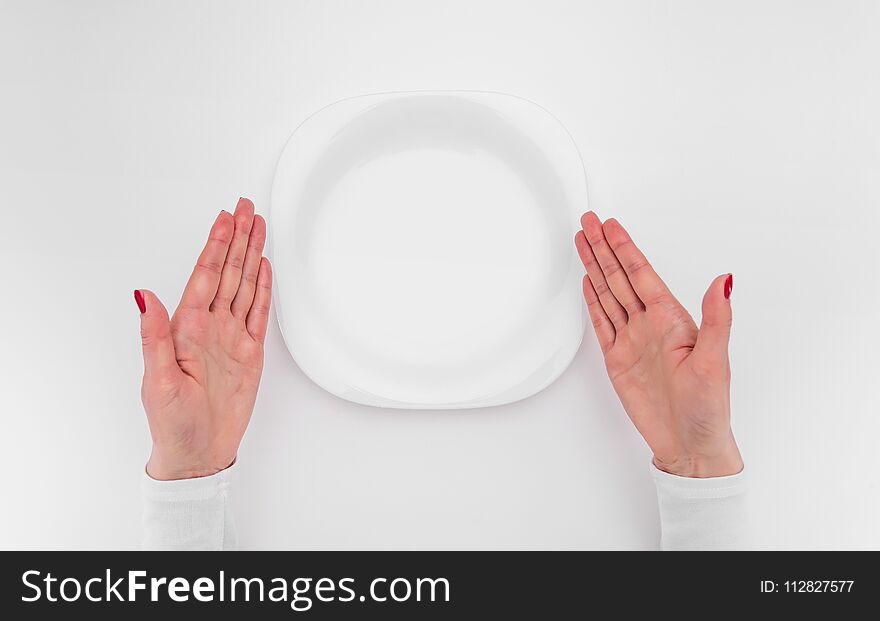 Female hands and an empty plate. A place to place your image.