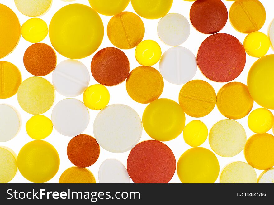 Many colorful medication pills on a white bright backlighting background. Many colorful medication pills on a white bright backlighting background.