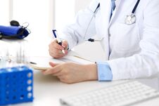 Female Doctor Filling Up Medical Form On Clipboard Closeup. Physician Finishing Up Examining His Patient In Hospital An Royalty Free Stock Photos