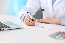 Female Doctor Filling Up Prescription Form While Sitting At The Desk In Hospital Closeup. Physician Finishing U Royalty Free Stock Photo Female Doctor Filling Up Prescription Form While Sitting At The Desk In Hospital Closeup. Physician Finishing U Royalty Free Stock Photo